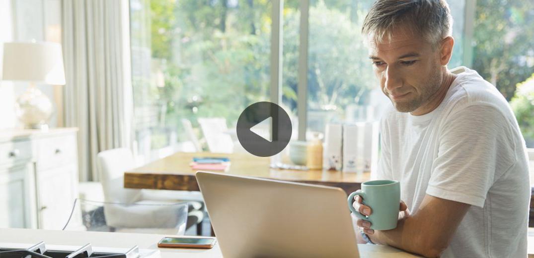 A man watches a video of Patelco members explaining why they love the credit union.